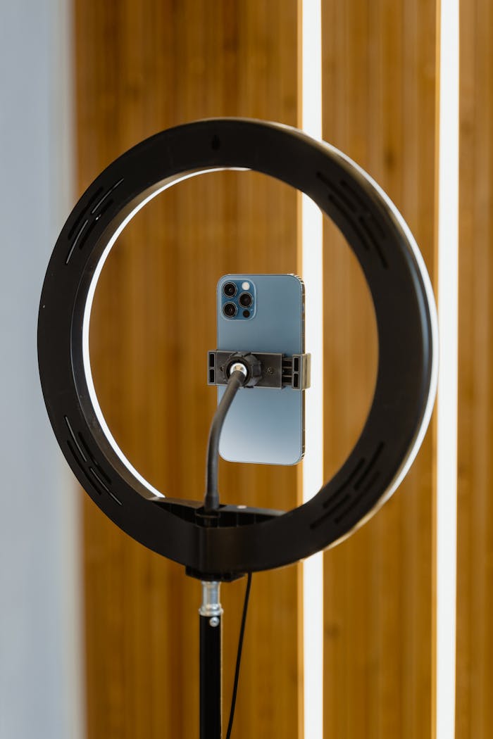 Smartphone mounted on ring light, perfect for content creators using mobile devices.